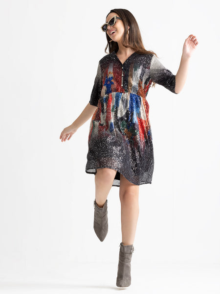 Model enjoying short sleeves on Jamie dress showing sequin stripe pattern on lightweight fabric