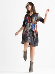 Model enjoying short sleeves on Jamie dress showing sequin stripe pattern on lightweight fabric
