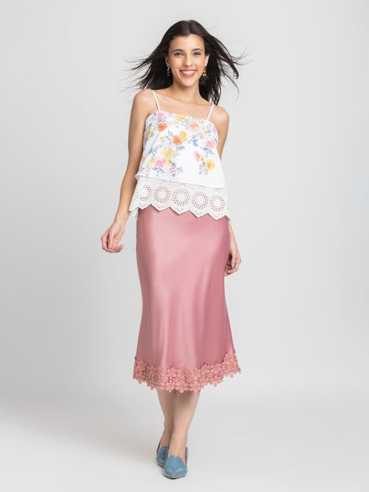 Model standing in Kagura Skirt styled with white top highlighting side zipper bias cut relaxed fit and lace hem