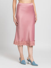 Side profile of Kagura Skirt showing dusty pink satin fabric side zipper and elegant lace detail at hem