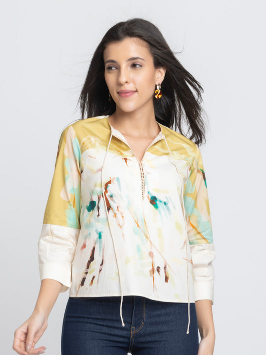 Model wearing beige printed Karissa Top with round neck slit tie up neckline three quarter sleeves and relaxed fit