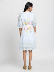 Back view of Poetry dress showing straight hem and belt tie detail on light blue cotton fabric