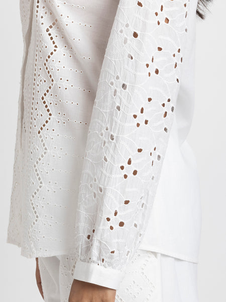 Extreme close-up, textured fringe beading and sequin embroidery detail on luminous beige satin sheath party dress