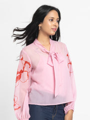 Side view of pink Maine Top showing elasticated full sleeves floral print and curved hem in soft chiffon fabric