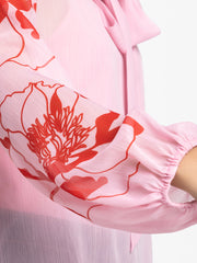 Close up of floral print and elasticated sleeve on pink Maine Top with soft chiffon fabric and curved hem