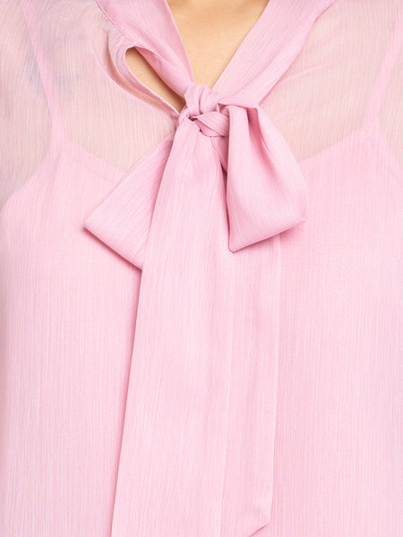 Close up of elegant tie up neck with bow detail on pink chiffon Maine Top showcasing light floral print