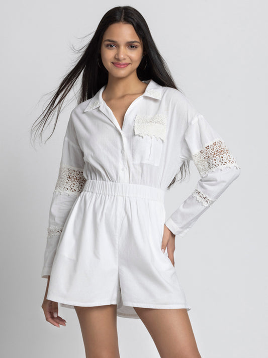 Model posing with hand on hip wearing white embroidered Maleah Playsuit with spread collar full sleeves and elasticated waist