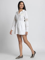 Side profile of model wearing Maleah Playsuit showing straight hem elastic waist and lace detailing on sleeves