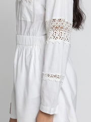 Close up of lace patch on full sleeve and elasticated waist on Maleah Playsuit in soft breathable cotton fabric