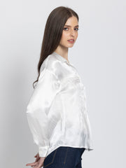Model casually posing in Minnie Shirt highlighting button down closure full sleeves and soft satin fabric