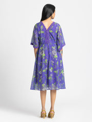 Rear view of Mucia Dress with zipper back crochet neckline and lace details on bell sleeves
