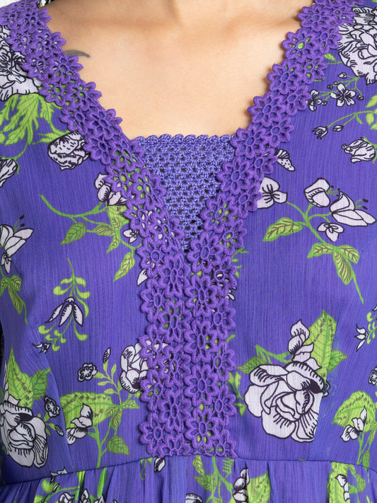 Close up of crochet embroidery neckline and floral print on purple chiffon Mucia Dress with lace trimmed sleeves