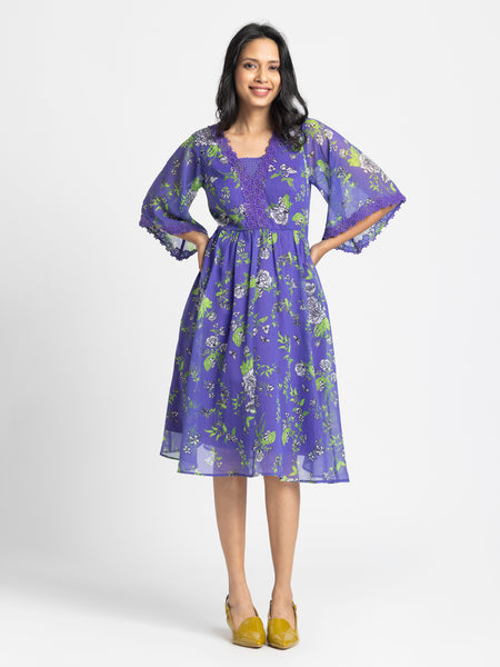 Side profile of Mucia Dress featuring crochet neckline bell sleeve lace trim and soft chiffon fabric