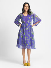 Side profile of Mucia Dress featuring crochet neckline bell sleeve lace trim and soft chiffon fabric