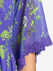 Close up of lace trim detail on bell sleeves and purple floral print chiffon Mucia Dress