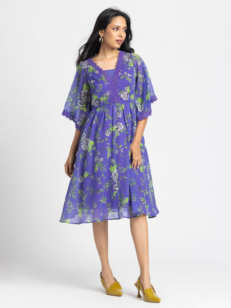 Model in three-quarter front pose wearing Mucia Dress highlighting bell sleeves lace trim and relaxed fit