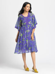 Model in three-quarter front pose wearing Mucia Dress highlighting bell sleeves lace trim and relaxed fit