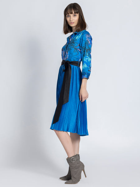 Side profile of Olga Dress featuring long cuff sleeves pleated skirt and belt on soft satin fabric
