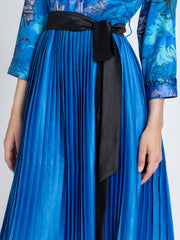 Close up of long cuff sleeve and floral print on blue satin Olga Dress featuring buttons and belt