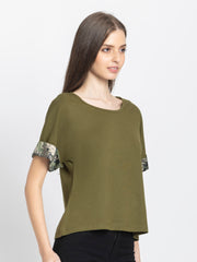 Right side profile of olive green Riya scoop neck t-shirt showing curved hemline and contrast printed sleeve design