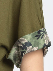 Close-up detail of camo printed sleeve accent on olive green Riya t-shirt made from soft stretchy jersey fabric