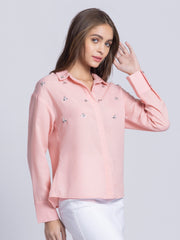 Front casual pose of peach Tamara party shirt showcasing shirt collar and long cuff sleeves in soft poly linen