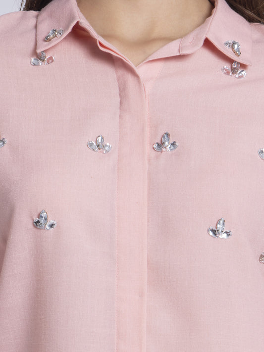Close-up detail of front embellishments on peach Tamara party shirt showing decorative beading on poly linen fabric