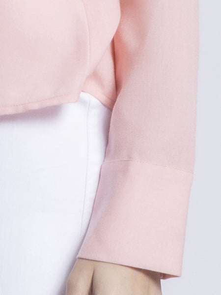 Close-up detail of long cuff sleeves on peach Tamara party shirt showing button down construction and fabric quality