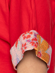 Close-up detail of floral printed sleeve accent on red Thea t-shirt made from soft stretchy jersey fabric