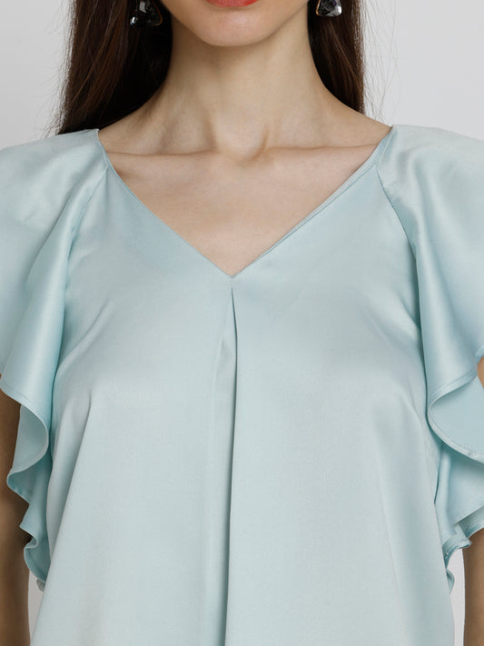 Close up of V-neck and inverted pleats on blue Rufina Top featuring soft flowy satin fabric and relaxed fit