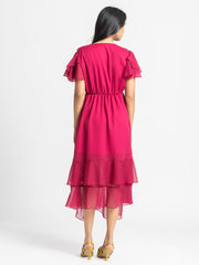 Rear view of Sebastina Dress highlighting soft chiffon relaxed fit short flared sleeves and layered asymmetric hem