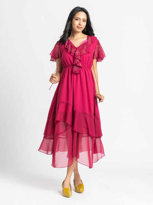Model standing in dark pink Sebastina Dress with V-neck ruffles front tie up neckline and asymmetric hem