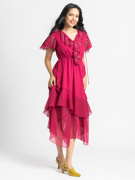 Model posing happily in Sebastina Dress highlighting ruffle details flared sleeves and relaxed fit silhouette