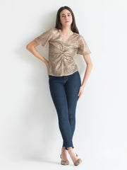 Shaye beige party top sequin v-neck twisted knot styled with jeans fitted full body view for women