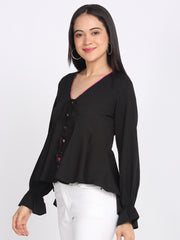 Side angle of black crinkled crepe peplum top v-neck button down full sleeves and tie at waist relaxed asymmetric hem