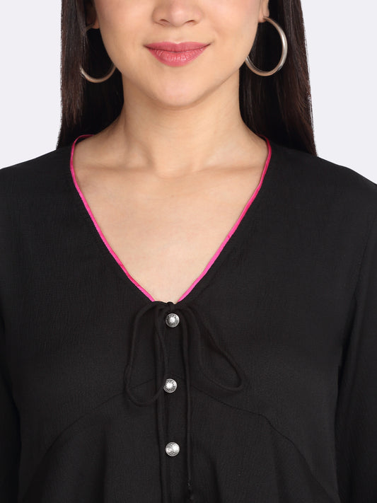 Close-up of v-neck with tie up and embroidered tassels button front detail on black peplum crinkled crepe top