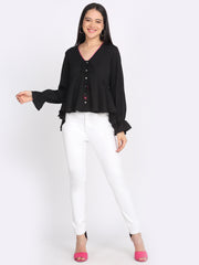 Black crinkled crepe peplum top styled with white pants v-neck tie up front button down relaxed fit full body view