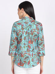 Back view of blue paisley print cotton shirt with gathers, cuffed three-quarter sleeves, and curved hem