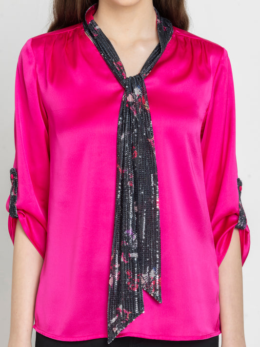 Close-up of v-neckline and printed sequin tie detail on fuchsia satin party top by Shaye for women