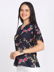 Side three-quarter pose navy blue floral print Kairo top v-neckline flared sleeves side slits curved hem