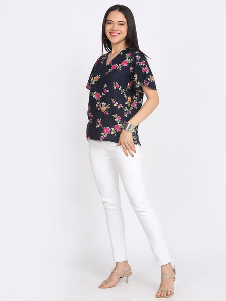 Navy blue Kairo top floral print v-neck short flared sleeves curved hem lifestyle model walking pose