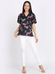 Full body view navy blue floral print viscose rayon v-neck top styled with white pants relaxed fit