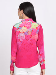 Back view of pink floral print shirt with collar, button sleeves, visible rose florals and curved hem