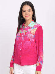Pink floral shirt with shirt collar, full sleeves, curved hem, white pants, expressive movement pose