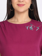 Close-up of boat neck and shoulder floral embroidery detail on purple crinkled crepe top