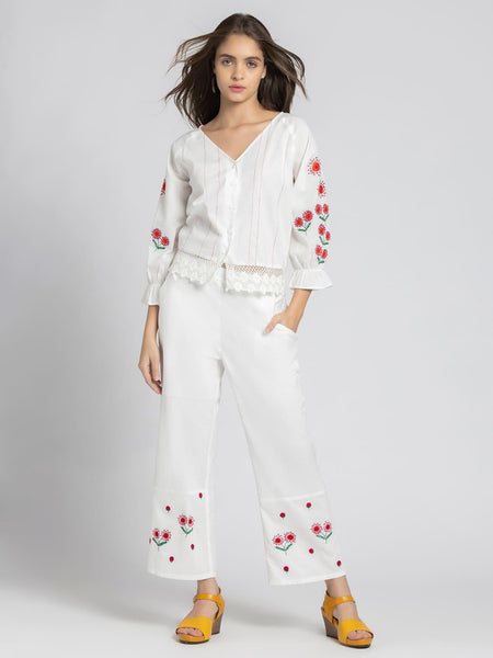 Model wearing white embroidered Sojourn Co-ord Set with crop top V-neck three-quarter elasticated sleeves and scallop hem