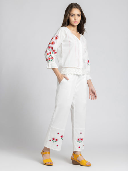 Model in three quarter front pose wearing embroidered Sojourn Co-ord Set showing scallop hem and button closure