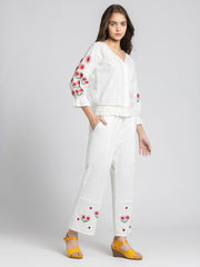 Model in three quarter front pose wearing embroidered Sojourn Co-ord Set showing scallop hem and button closure