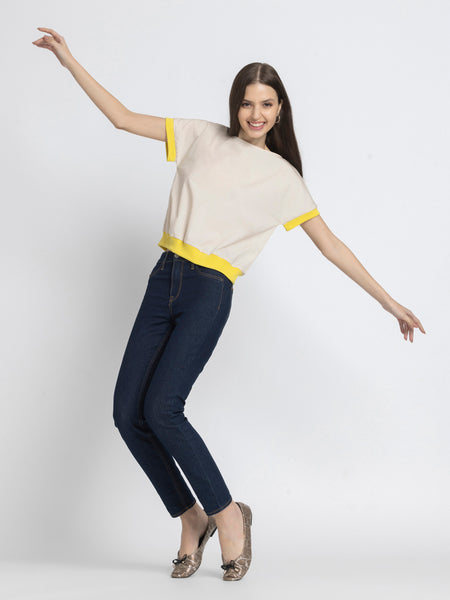 Model jumping in Sullivan Top and jeans highlighting ultra soft breathable cotton and straight hem
