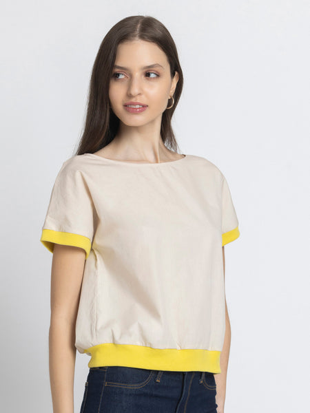 Side profile of Sullivan Top showing drop shoulder short sleeves yellow rib detail and ultra soft cotton